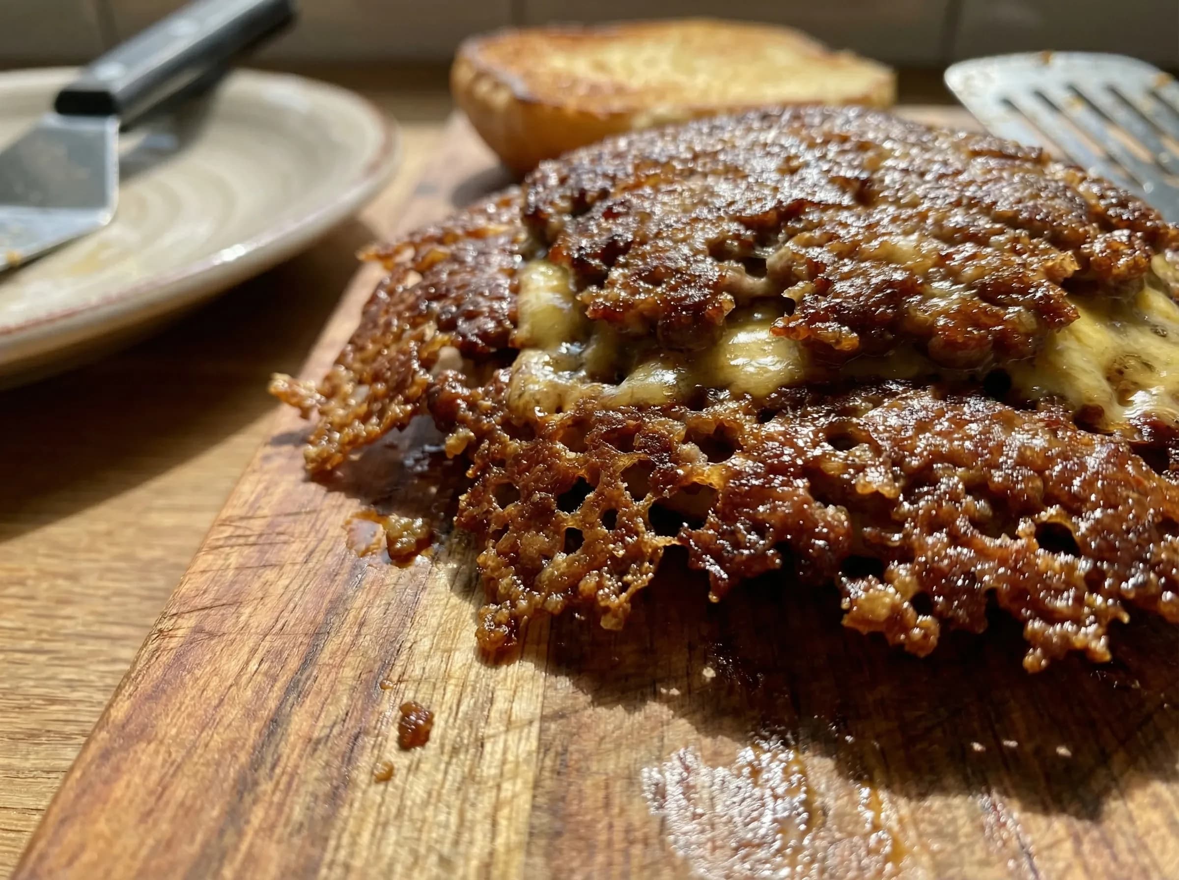 Close-up of smash burger with lacey crispy edges and caramelized crust